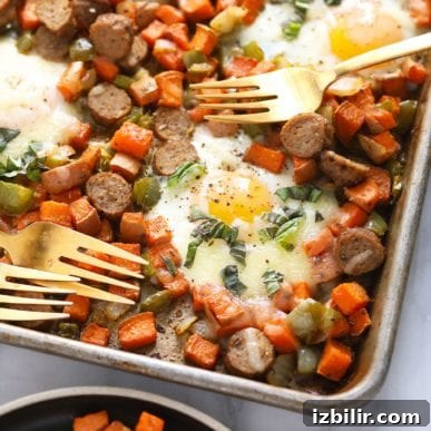 sweet potato hash with eggs on sheet pan with forks