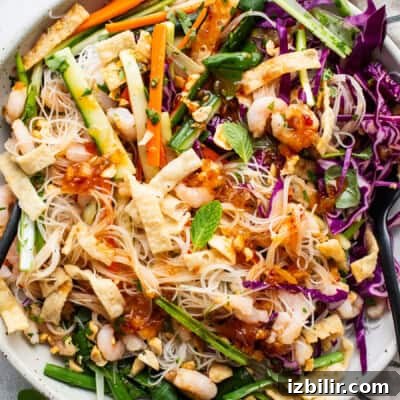 10 High-Protein Spring Recipes to Refresh Your Menu 6 A bowl of asian noodle salad with shrimp and vegetables.