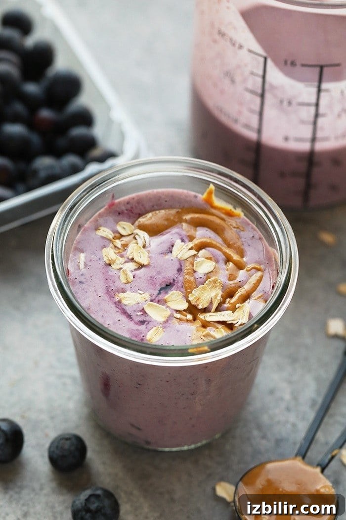 Creamy Peanut Butter and Jelly Smoothie Recipe 2 peanut butter and jelly smoothie in glass.