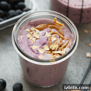 Creamy Peanut Butter and Jelly Smoothie Recipe 7 a peanut butter and jelly protein smoothie in a mason jar.