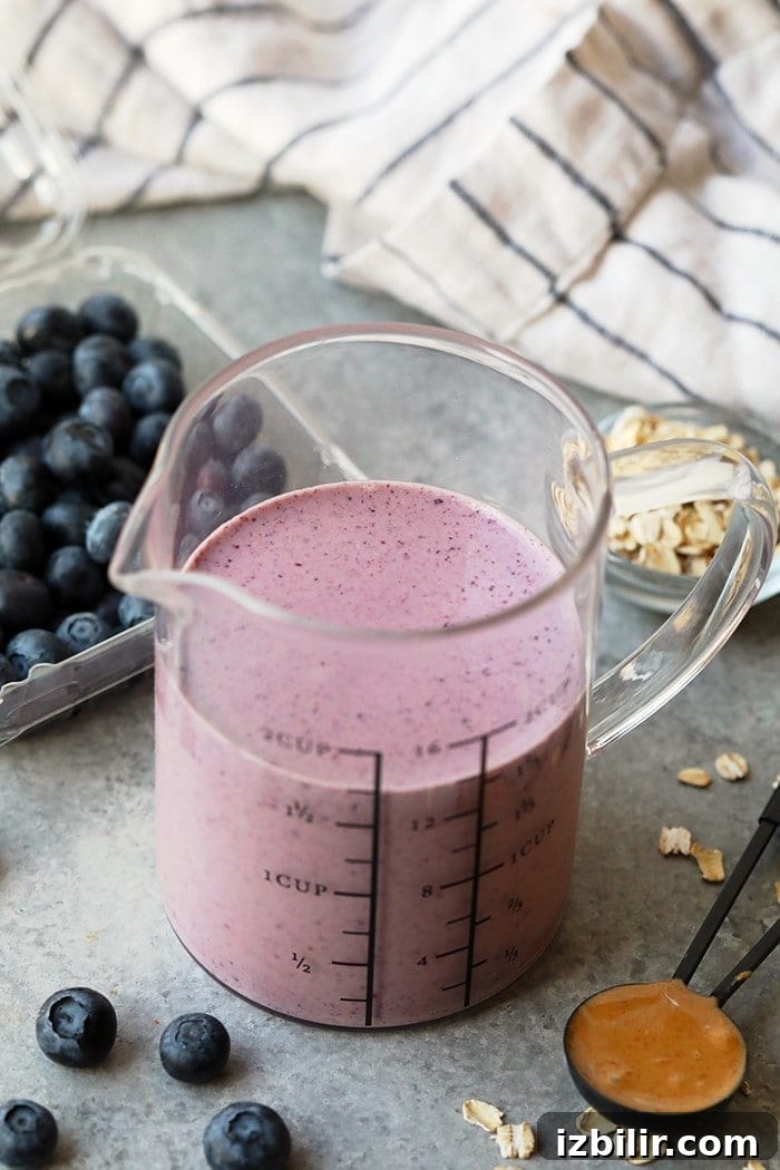 Creamy Peanut Butter and Jelly Smoothie Recipe 4 smoothie in a beaker.