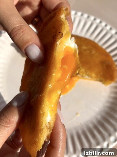 Golden fried arepa stuffed with egg