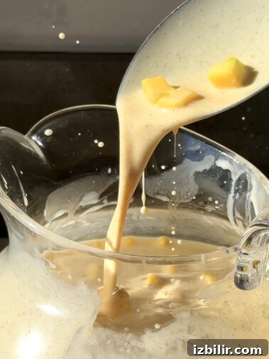Pitcher of mango horchata with ice and mango chunks