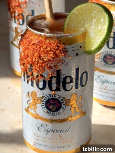 Open Can Micheladas served in beer can with Tajín-rimmed edge and lime wedge