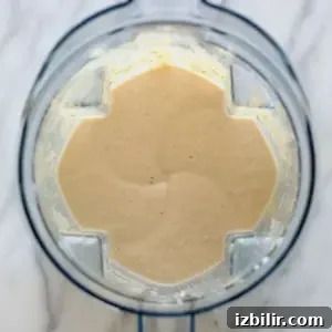 A food processor filled with a mixture of banana protein shake ingredients.