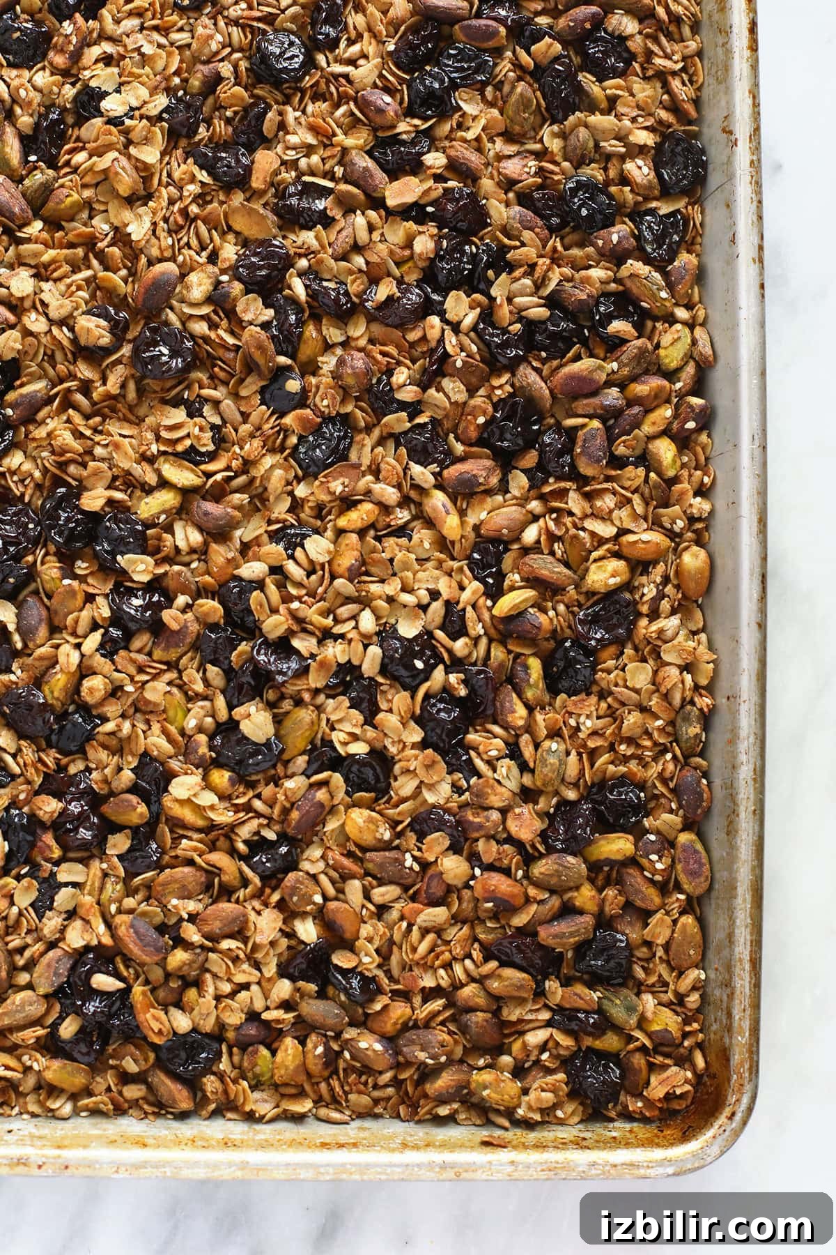 Homemade Pistachio Cherry Granola 5 Granola on a baking sheet.