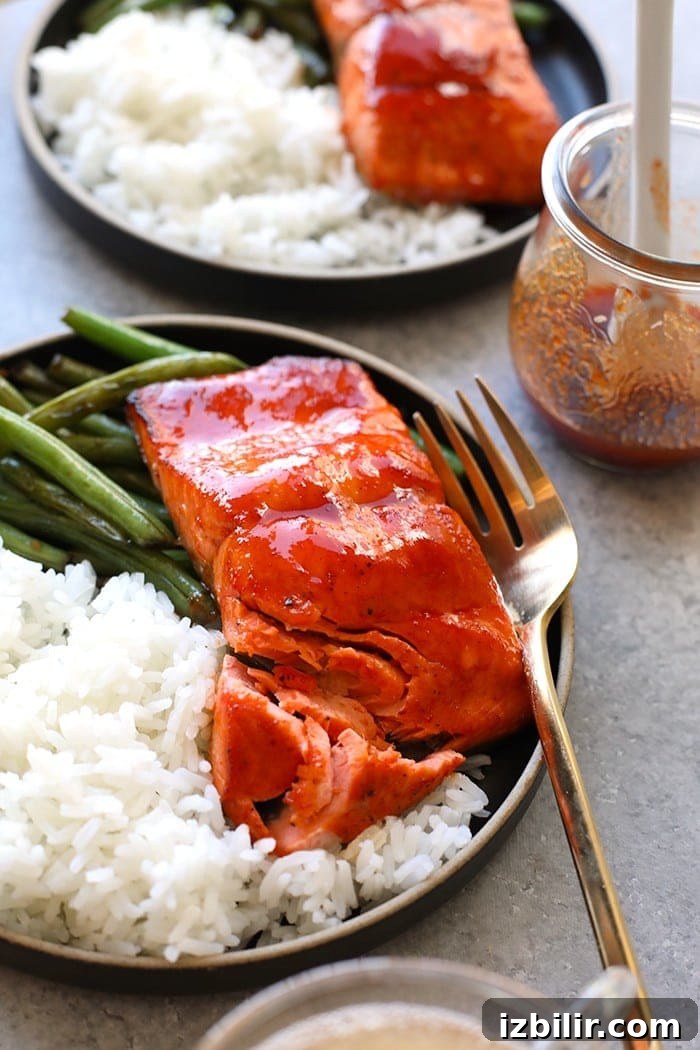 Serve honey sriracha salmon with rice and veggies honey sriracha salmon on plate with white rice and green beans
