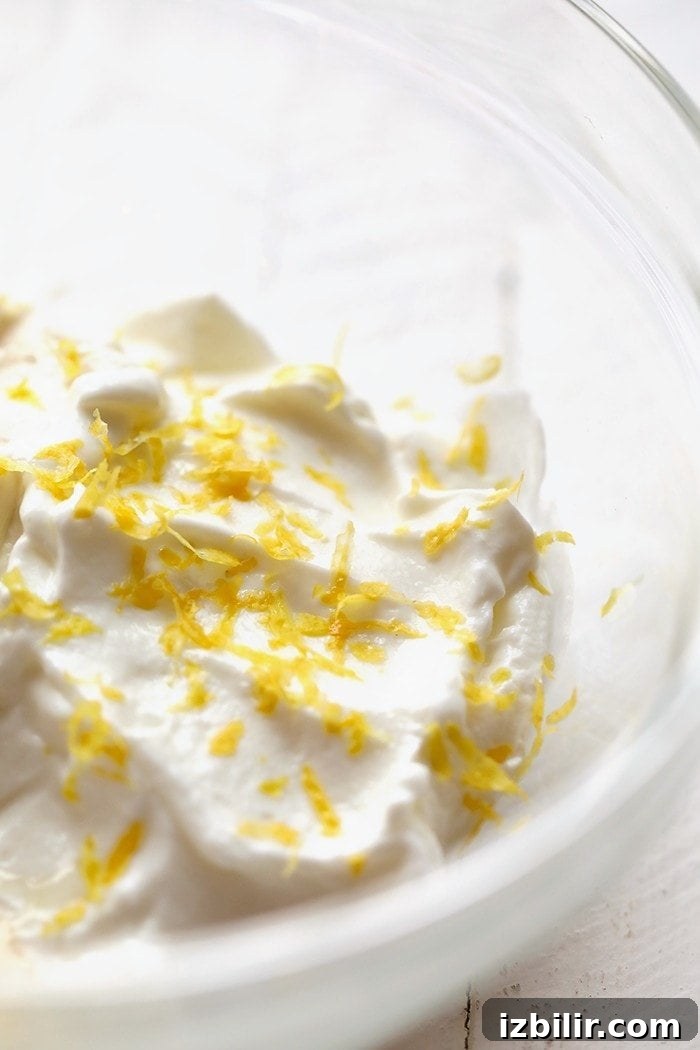 A bowl with greek yogurt and lemon zest.