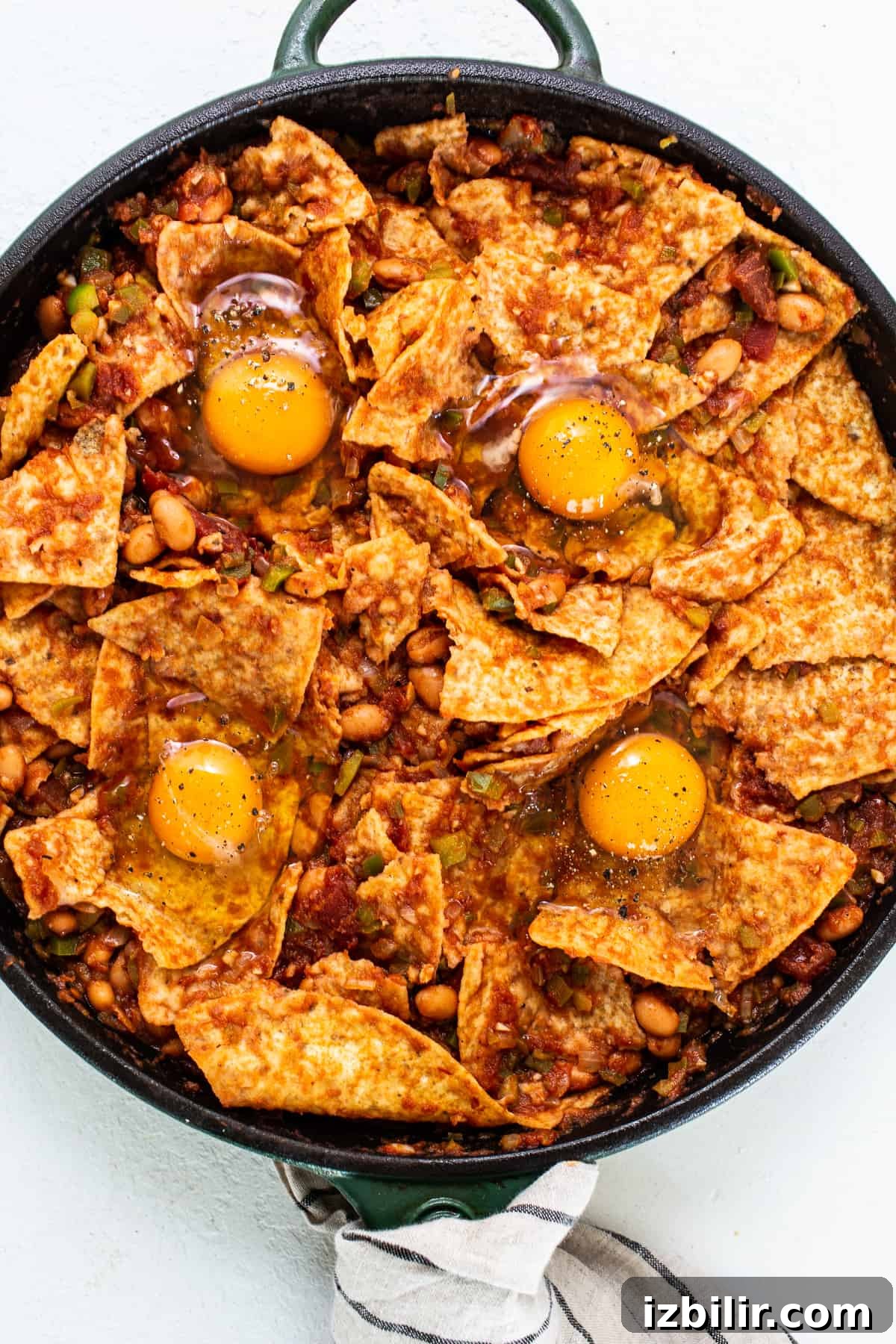 Quick Homemade Chilaquiles Recipe 3 chilaquiles with eggs on top.