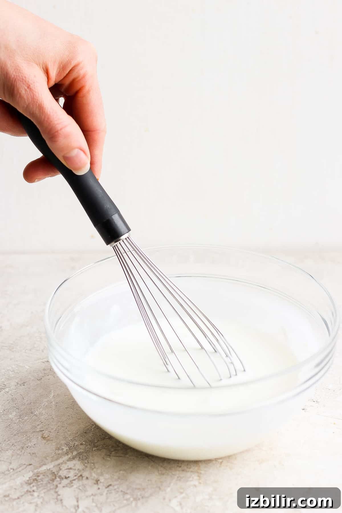 whisking dressing in bowl.