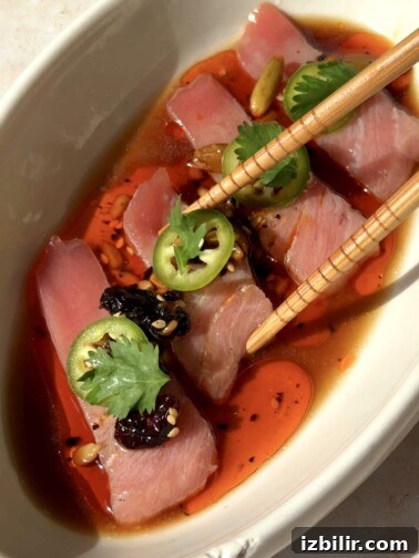 Salsa Macha Tuna Tiradito — thin slices of tuna arranged on a plate with salsa macha and garnishes