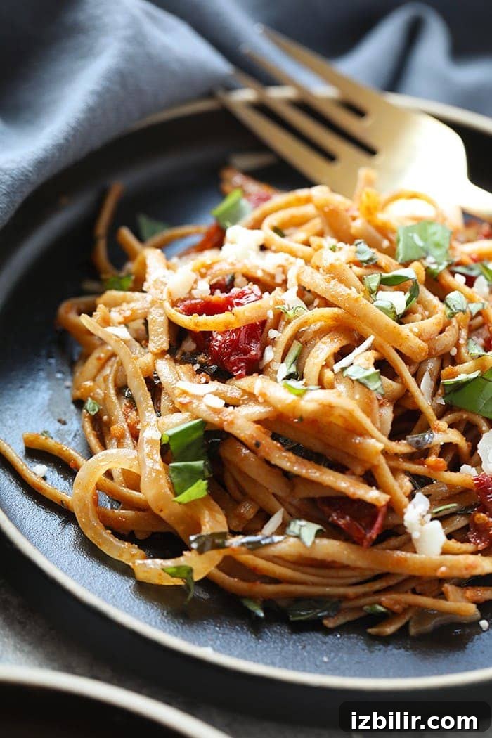 Pasta can be a healthy dinner packed with flavor and deliciousness. Substituting whole wheat pasta, adding vegetables, and creating a flavorful sauce is the key a healthy pasta for dinner. Treat yourself to this Whole Wheat Sun Dried Tomato Basil Pasta. It's light, fresh, and only require a few simple ingredients! whole wheat sun dried tomato pasta on plate