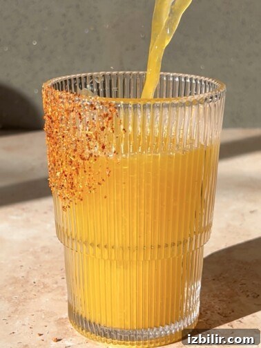 Pitcher of passionfruit margarita with garnish