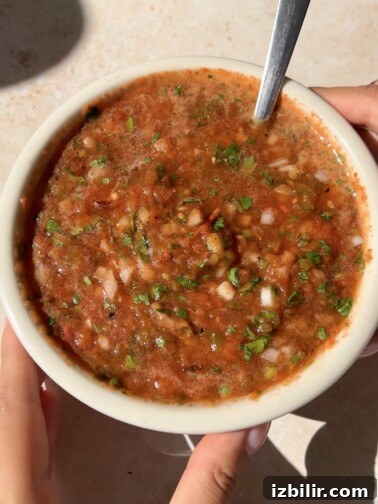 Chirmol Guatemalteco salsa in a small bowl with chopped cilantro
