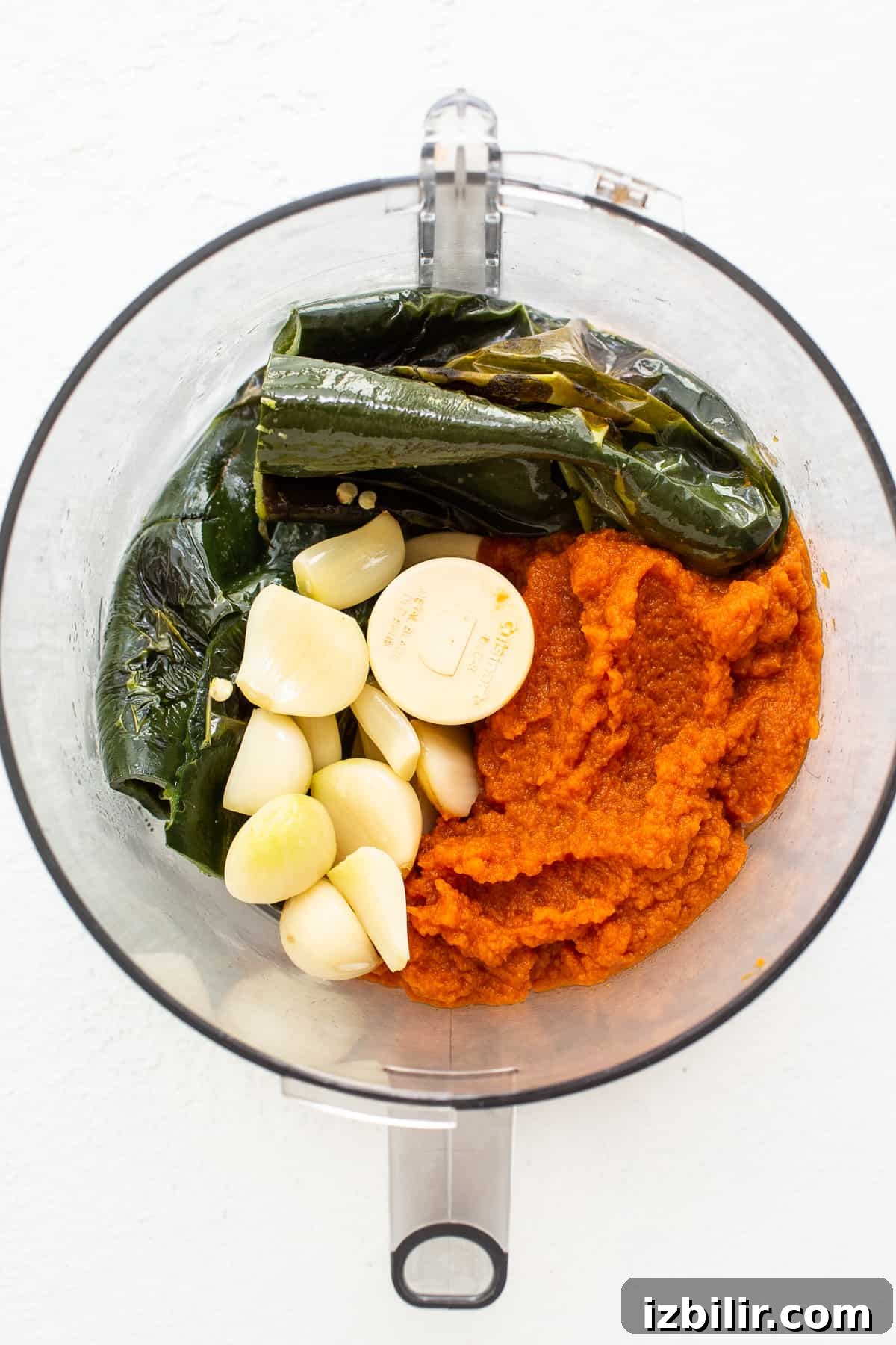 Pumpkin Chili Recipe for Cozy Fall Dinners 4 Pumpkin, garlic, and peppers in a food processor.