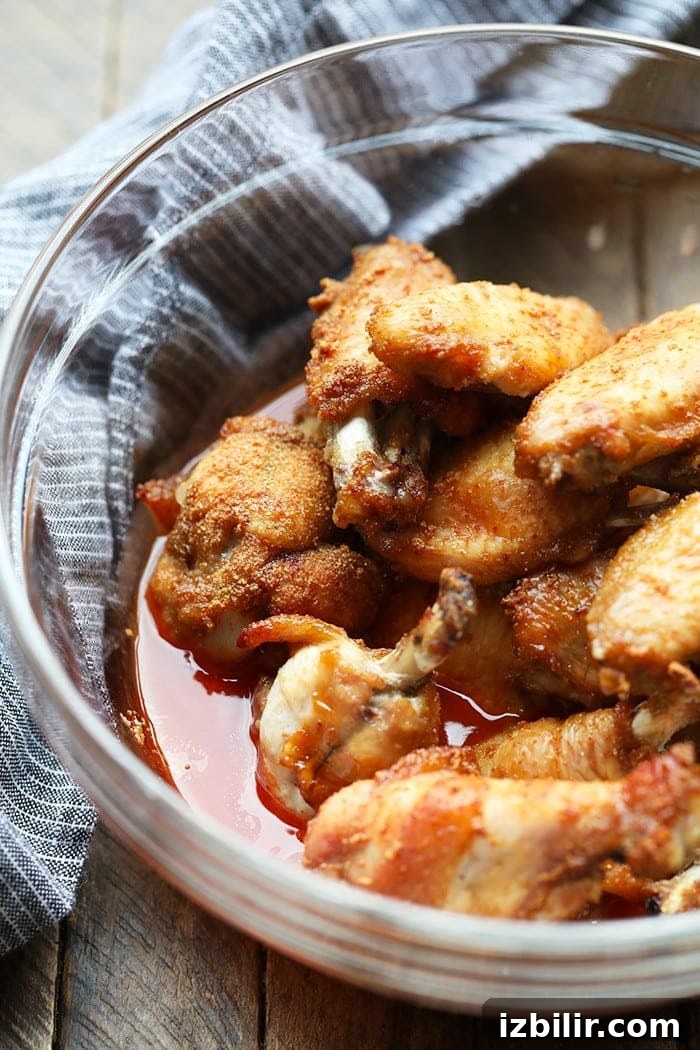 Crispy Baked Buffalo Chicken Wings Recipe 4 buffalo chicken wings being marinated in glass bowl