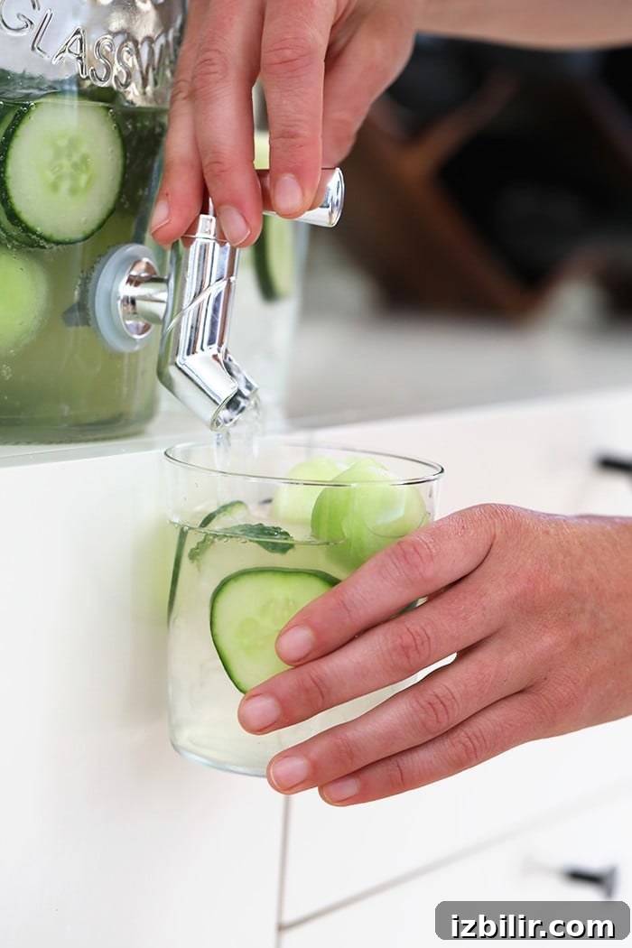 Refreshing cucumber vodka cocktail cucumber vodka drink dispensed in glass with cucumber slices