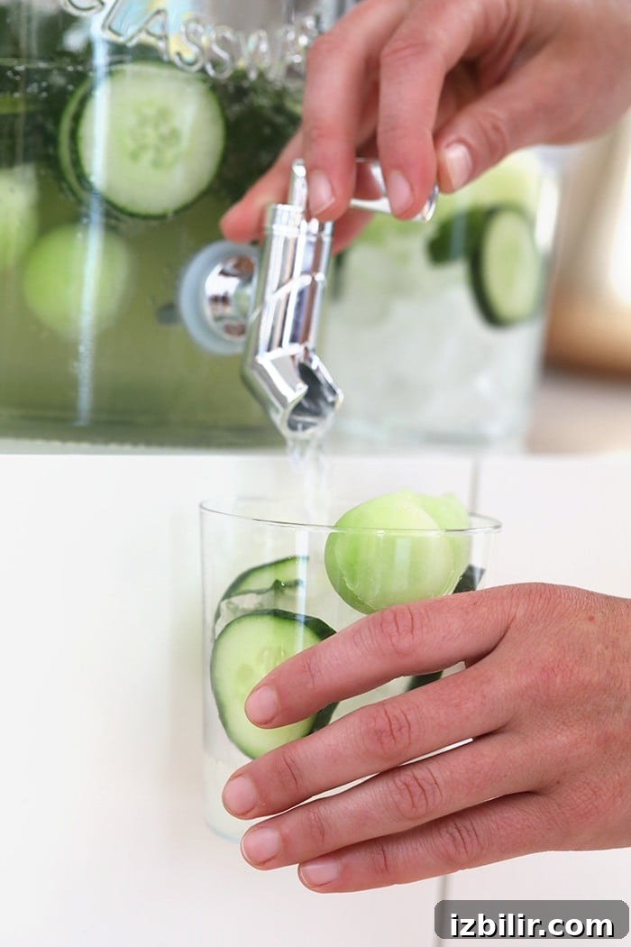 Pouring cucumber vodka drinks cucumber vodka drinks being dispensed in glass