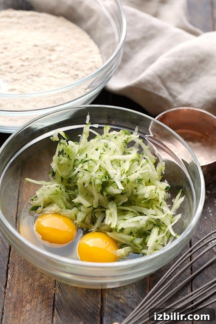 You will absolutely love this zucchini waffle recipe because it's made with whole wheat flour, shredded zucchini, coconut oil, and real maple syrup. shredded zucchini and eggs