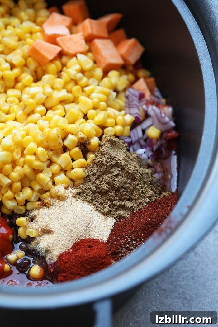 Uncooked ingredients assembled in slow cooker Mexican quinoa ingredients, uncooked, in slow cooker