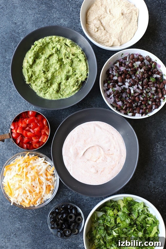 Ingredients for Healthy Taco Dip healthy taco dip ingredients in bowls ready to be mixed