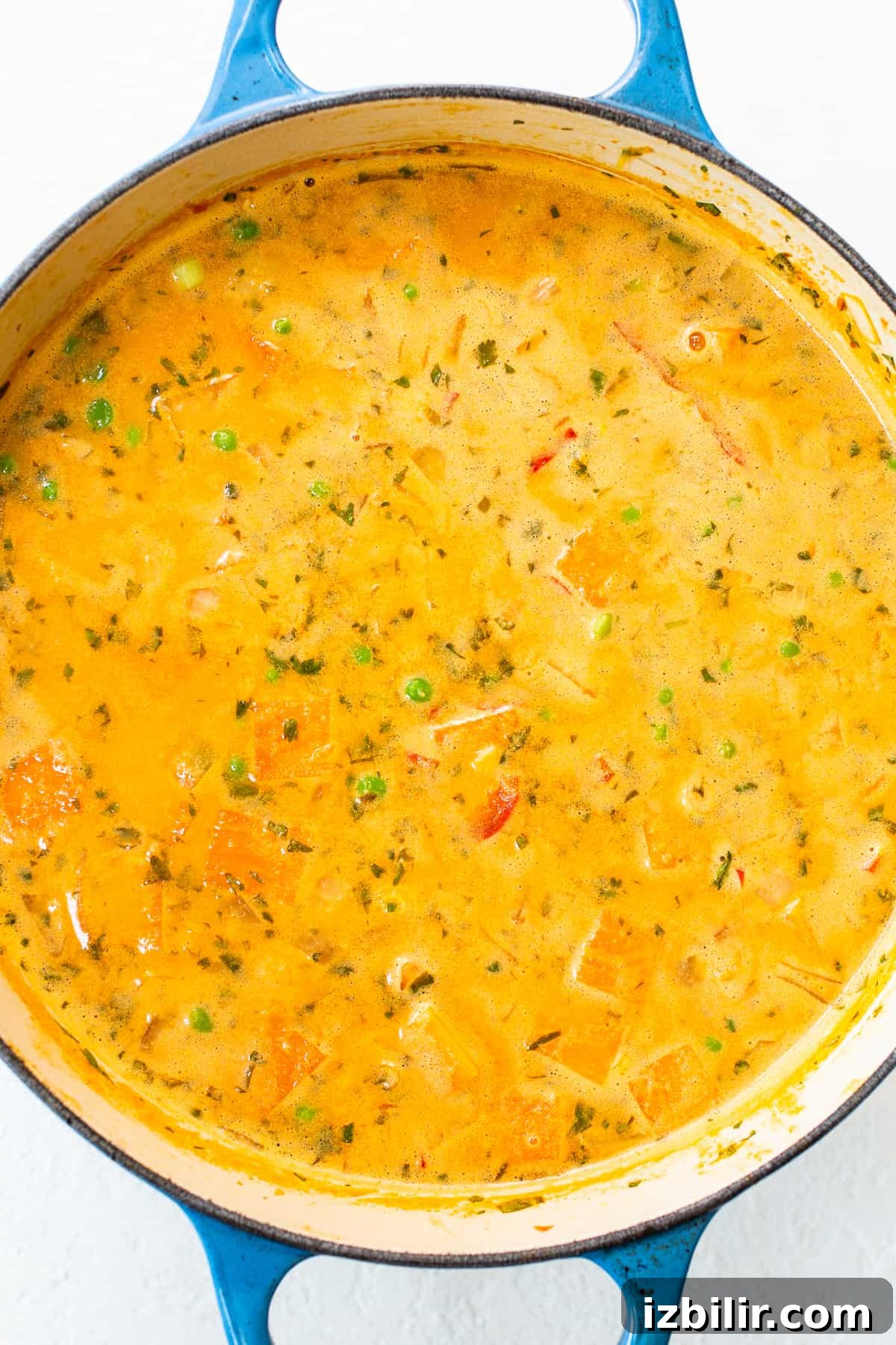 Creamy Thai Coconut Curry Soup with Lime and Ginger 4 A bowl of soup in a blue pot.