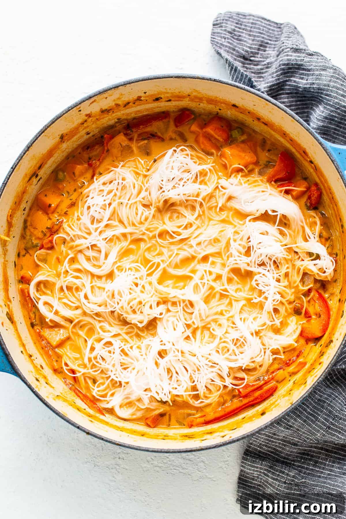 Creamy Thai Coconut Curry Soup with Lime and Ginger 5 A dish with noodles and vegetables in it.