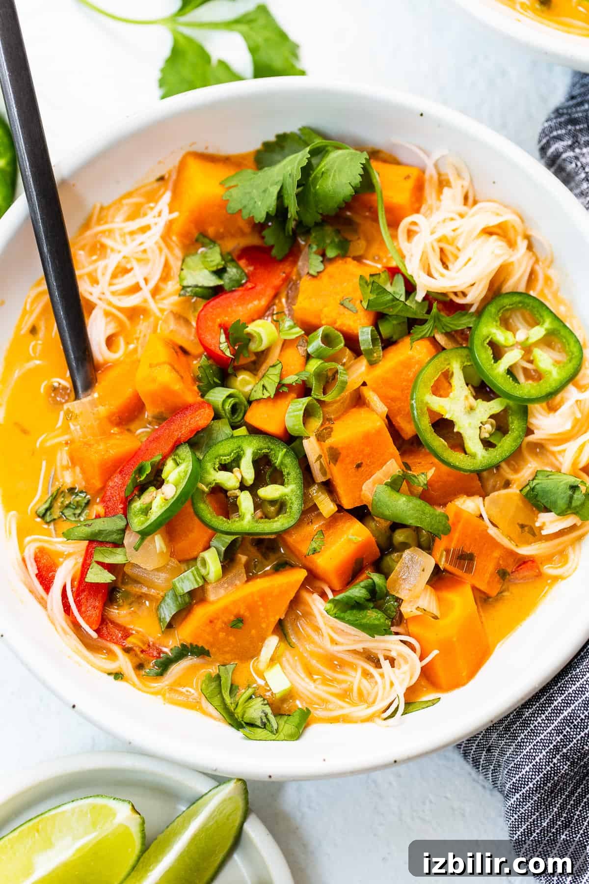 Creamy Thai Coconut Curry Soup with Lime and Ginger 7 A bowl of soup with toppings.