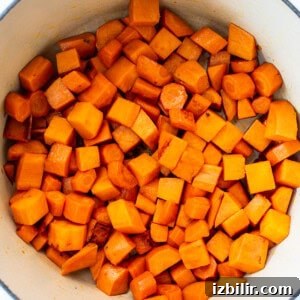 Creamy Thai Coconut Curry Soup with Lime and Ginger 9 Cubed sweet potatoes in a blue pot.