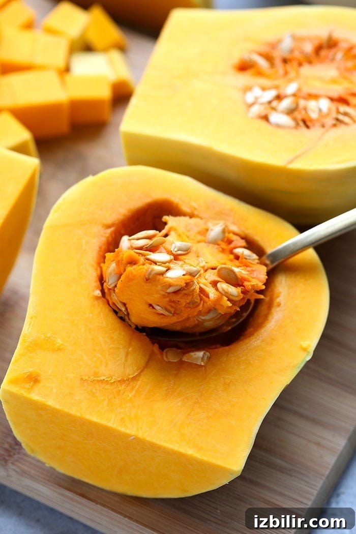 Butternut squash cut in half on a cutting board
