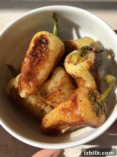 Golden blistered chiles güeros seasoned with lime and Tajín
