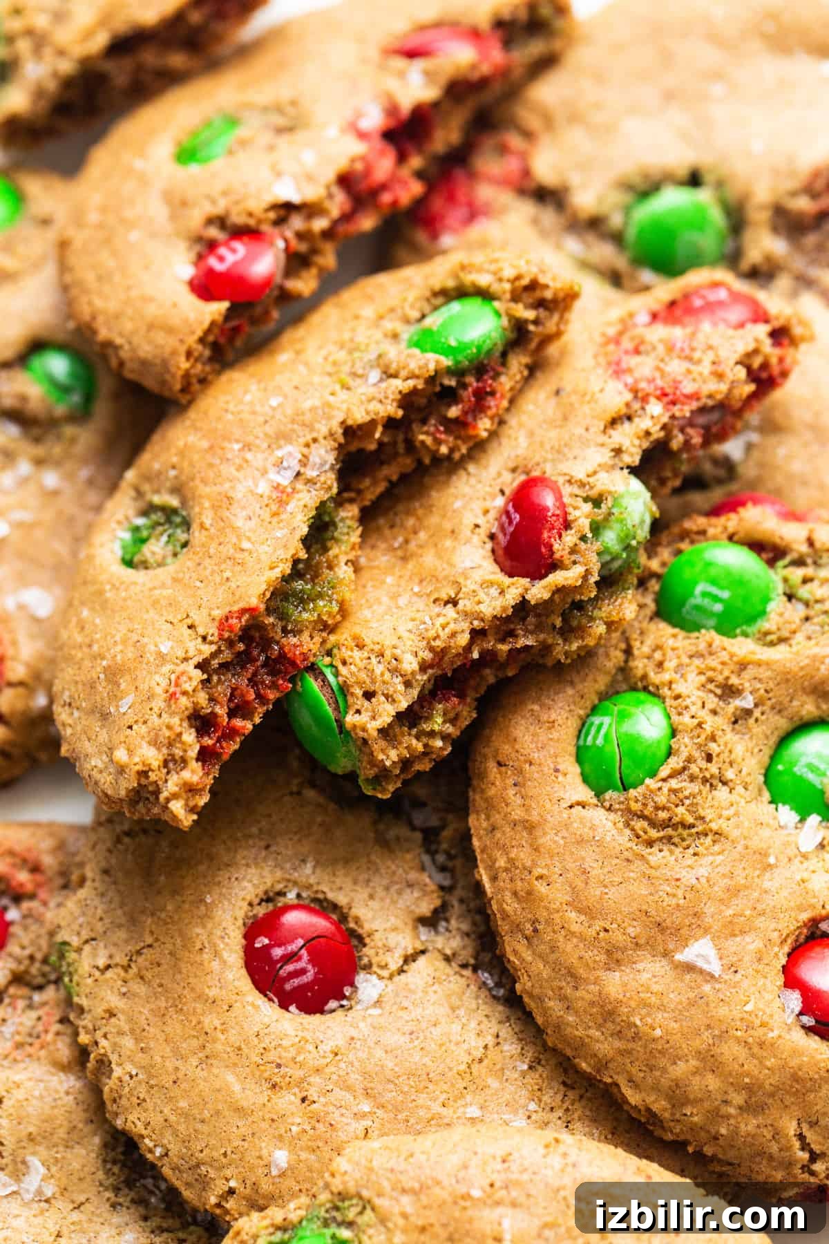 A pile of cookies with m & m's on top.