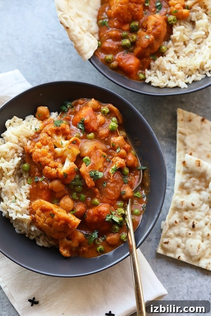 Cauliflower Tikka Masala Tikka masala in a bowl with naan on the side