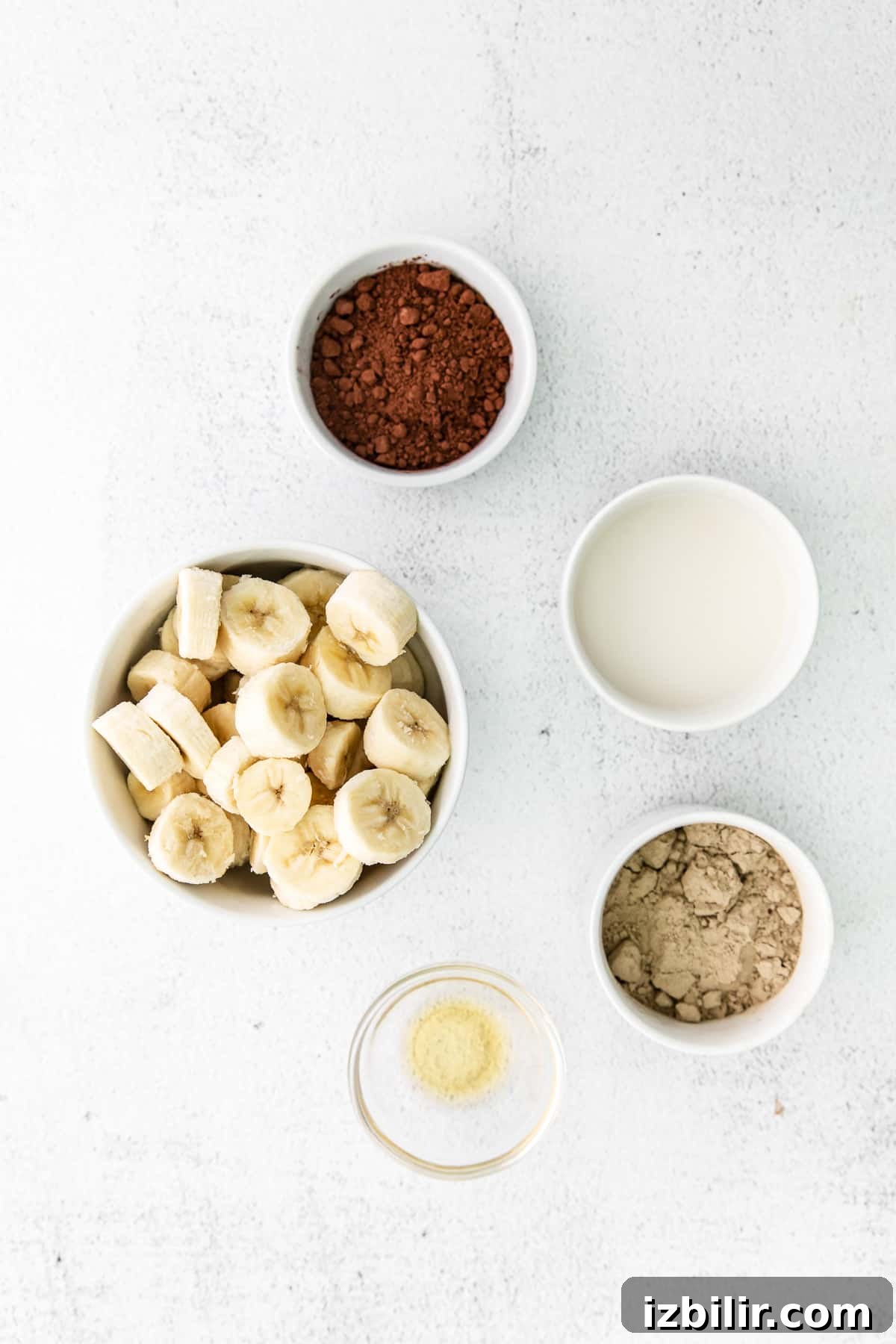 All the ingredients for protein ice cream in small bowls.