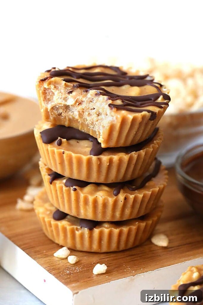 No-Bake Peanut Butter Crunch Cups Recipe 2 A stack of peanut butter cups on a cutting board.