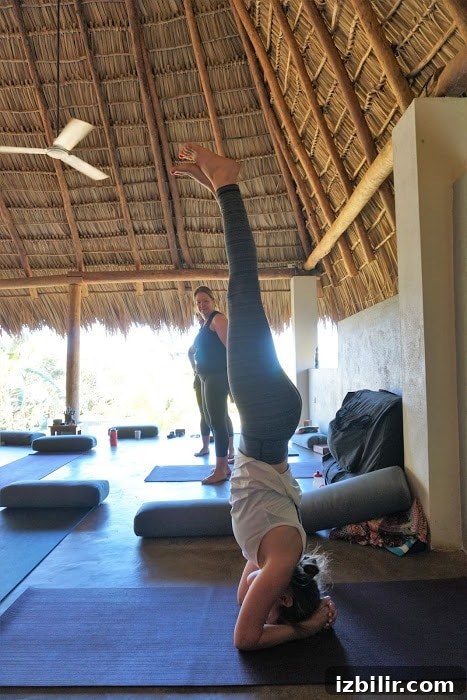 Nicaragua is the perfect location for a beach yoga adventure! Person doing a headstand.
