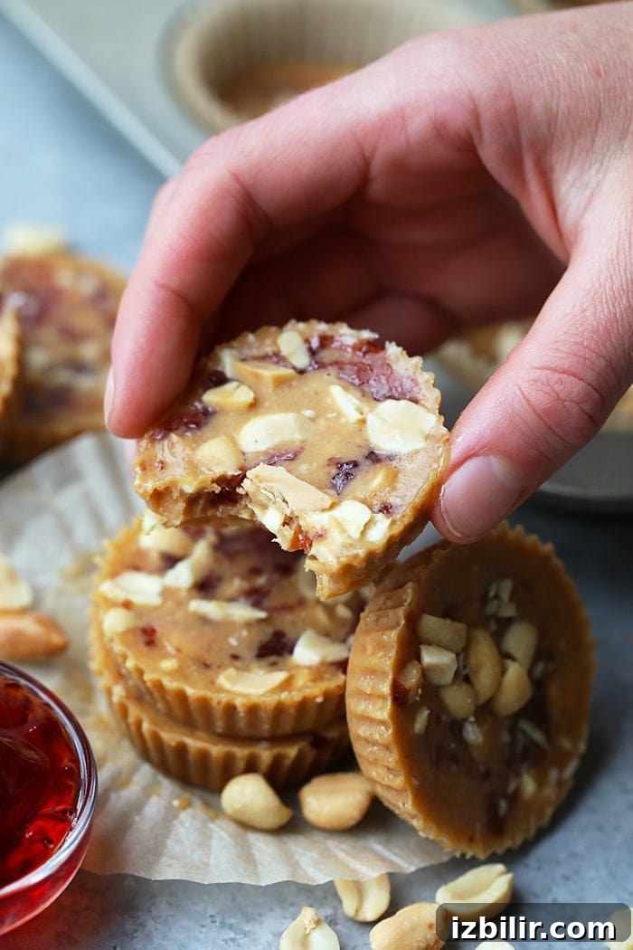 Hand holding a peanut butter and jelly nut butter cup