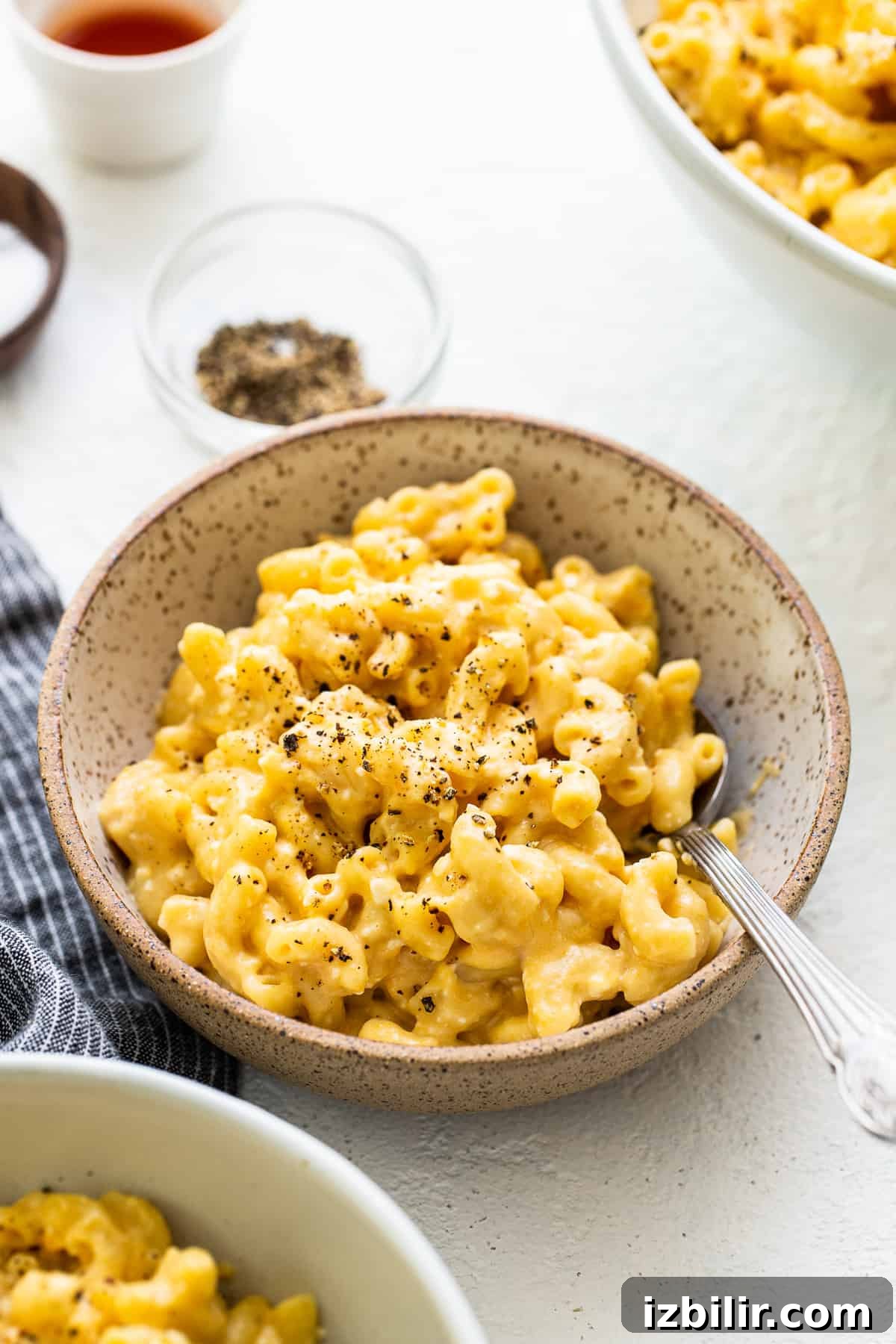 Made with 17g of protein and completely in your Instant Pot, this Protein Mac and Cheese is delicious, creamy, and easy to make! mac and cheese with cracked pepper in bowl.