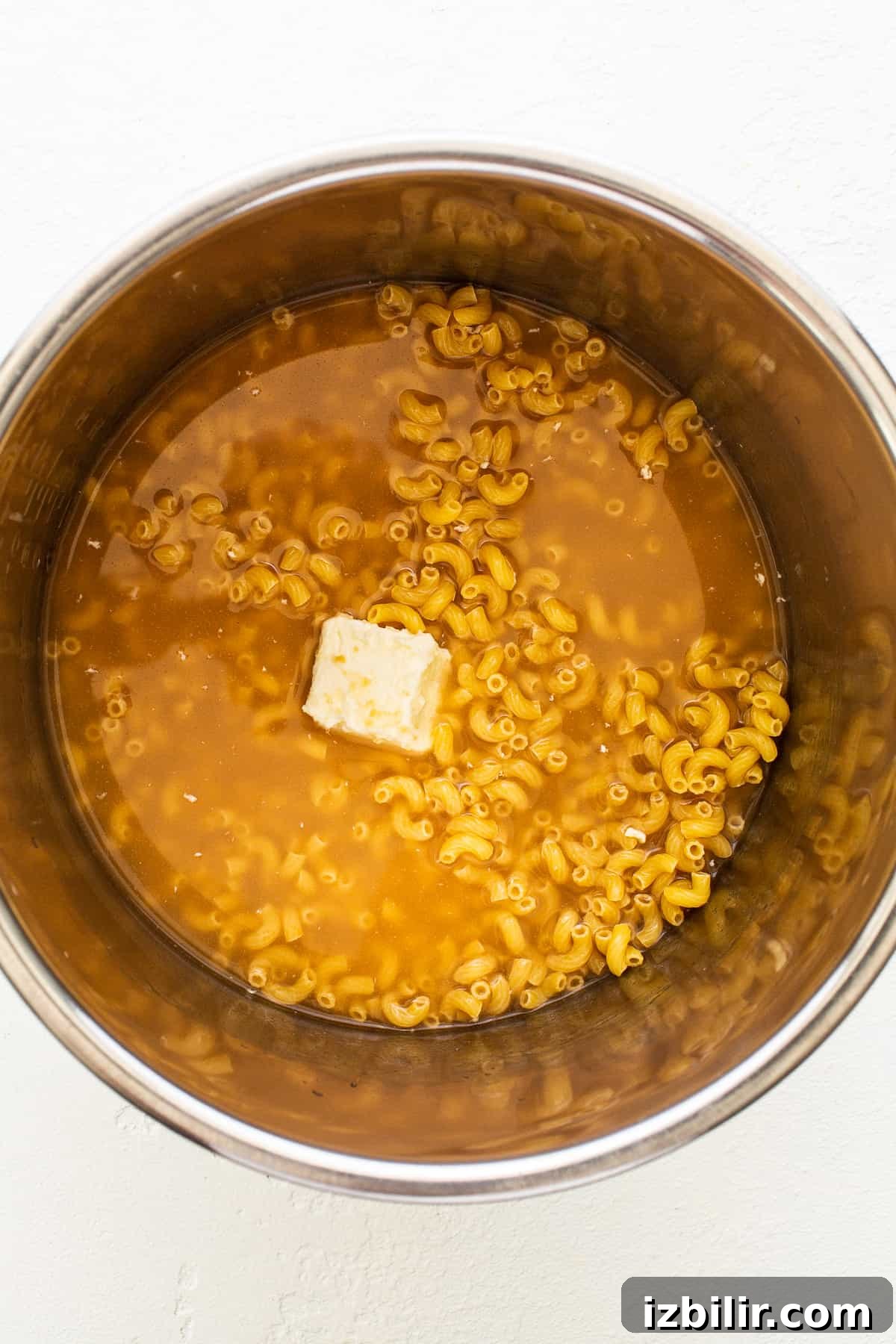 Made with 17g of protein and completely in your Instant Pot, this Protein Mac and Cheese is delicious, creamy, and easy to make! noodles, butter, and broth in Instant Pot.