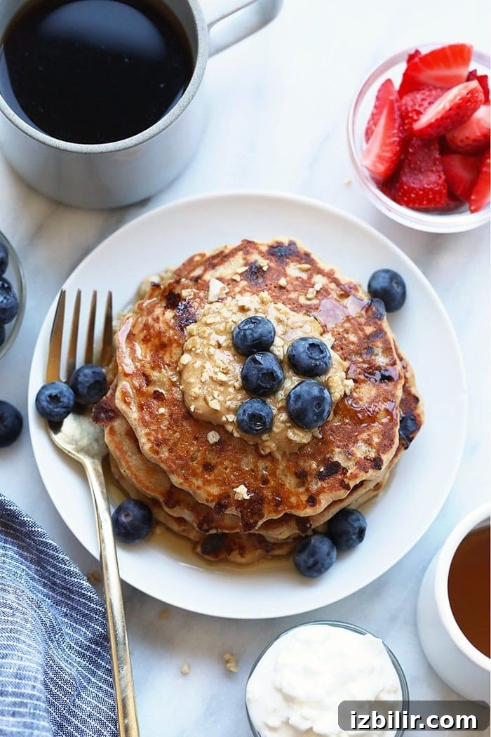Fluffy Cottage Cheese Pancakes Recipe 5 Protein pancakes on plate with peanut butter