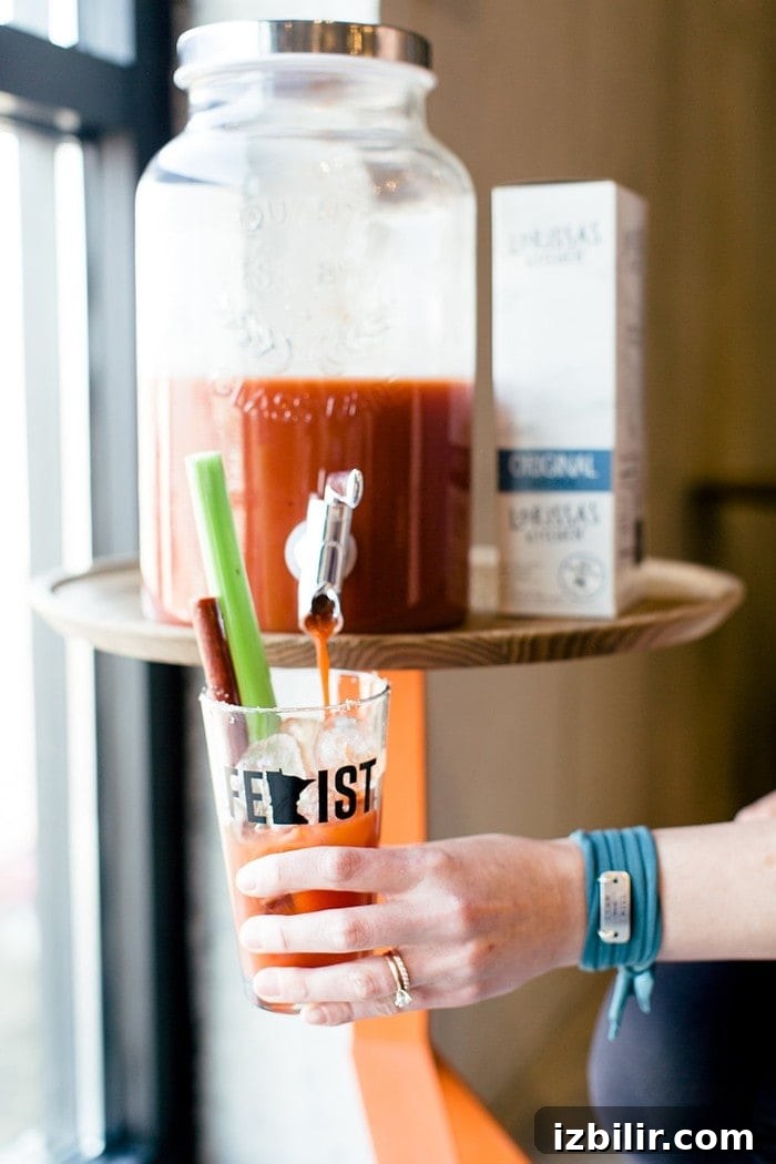 Bloodys and Bouldering Bloody Mary Pouring into Cup