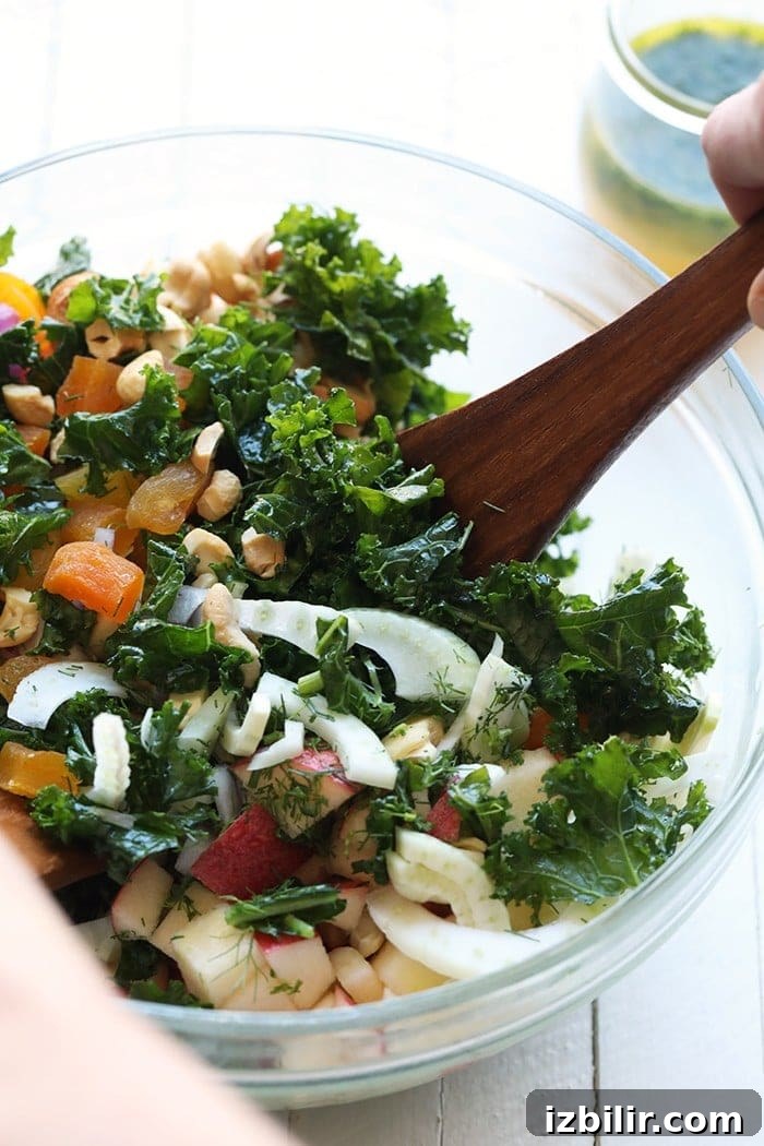 Mixing the salad Mixing the massaged kale salad in a bowl.