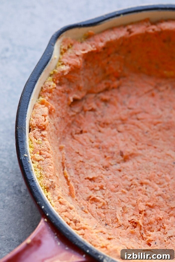 This sweet potato crust quiche has the most amazing crust that's made with sweet potatoes and almond flour. The quiche is packed with eggs, veggies, and goat cheese. sweet potato crust in pan
