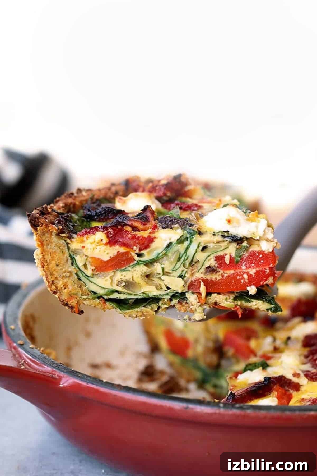 This sweet potato crust quiche has the most amazing crust that's made with sweet potatoes and almond flour. The quiche is packed with eggs, veggies, and goat cheese. sweet potato crust quiche piece