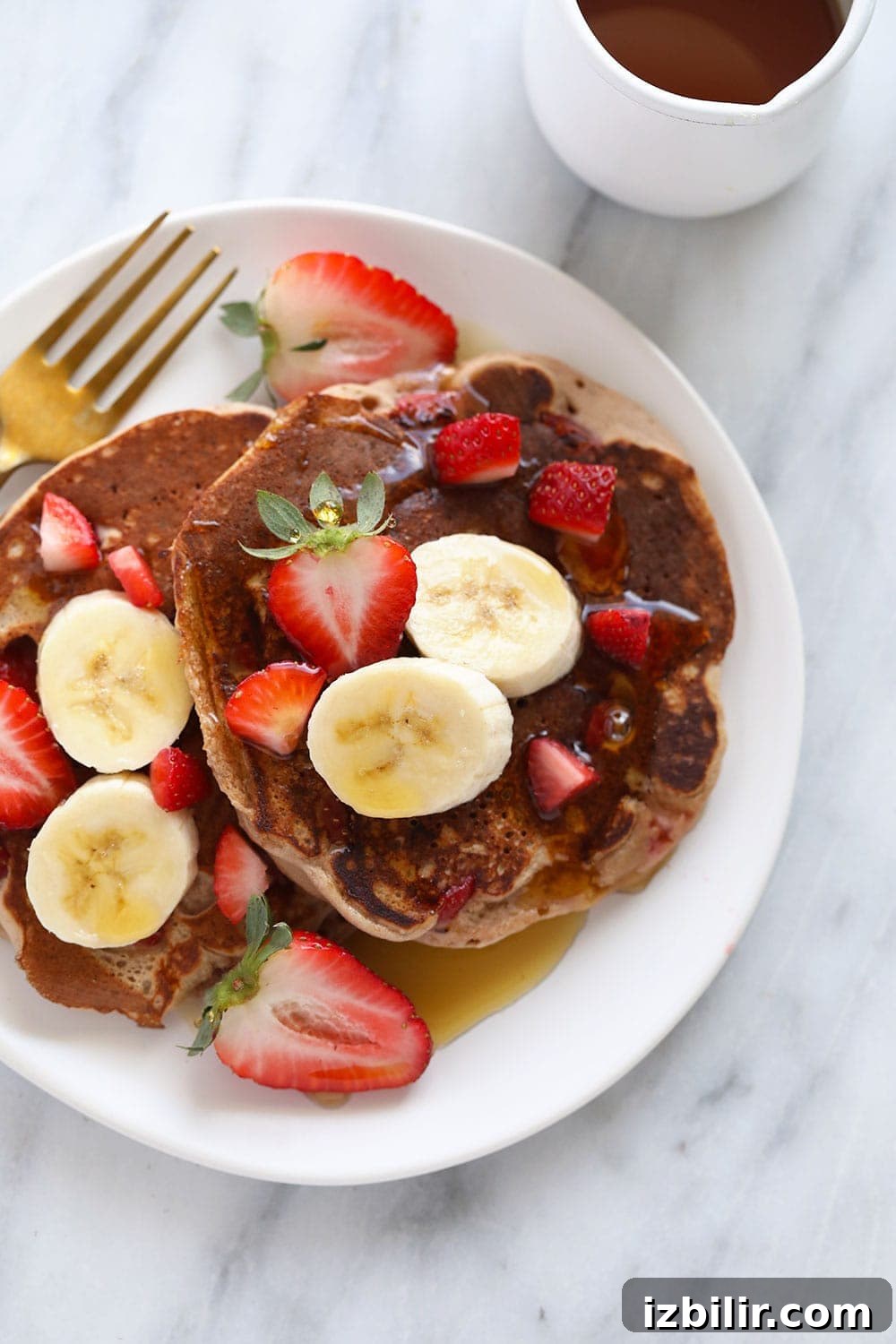 Stacked strawberry pancakes pancakes on plate