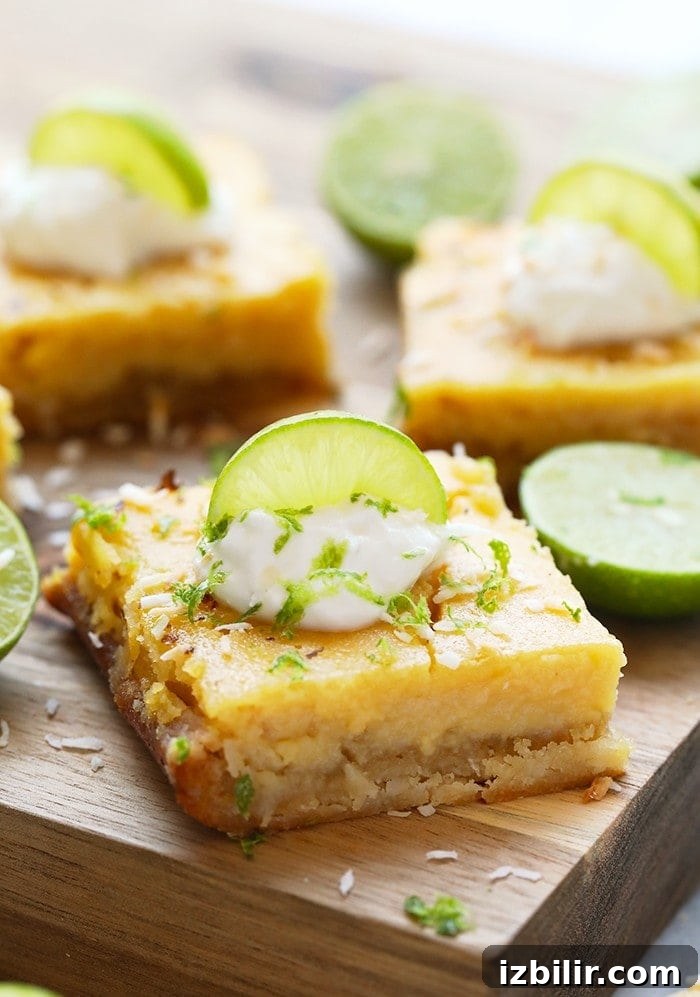 Finished coconut key lime pie bars ready to serve. Finished key lime pie bars