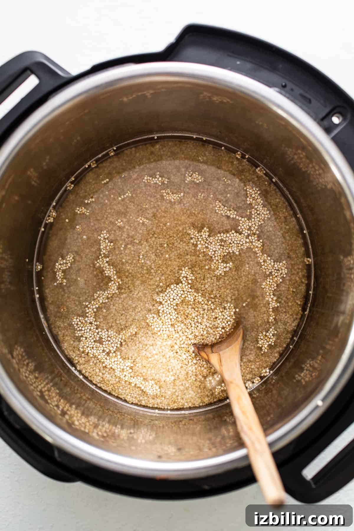 Liquid and quinoa in an Instant Pot. Liquid and quinoa in an Instant Pot.