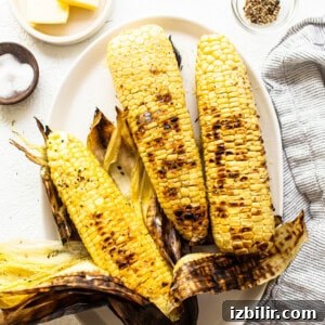 Smoky Grilled BBQ Chicken Bowls Recipe with Rice and Veggies 2 Three ears of corn on a plate