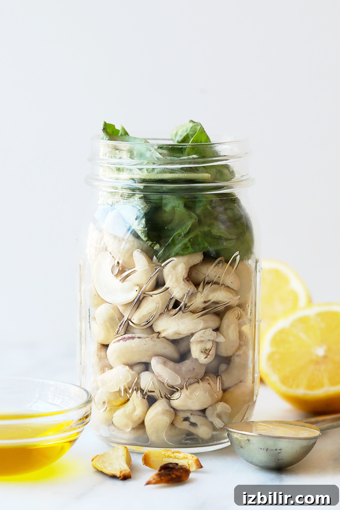Vegan pesto pasta in a jar ready for storage or meal prep. Vegan pesto pasta in a jar.