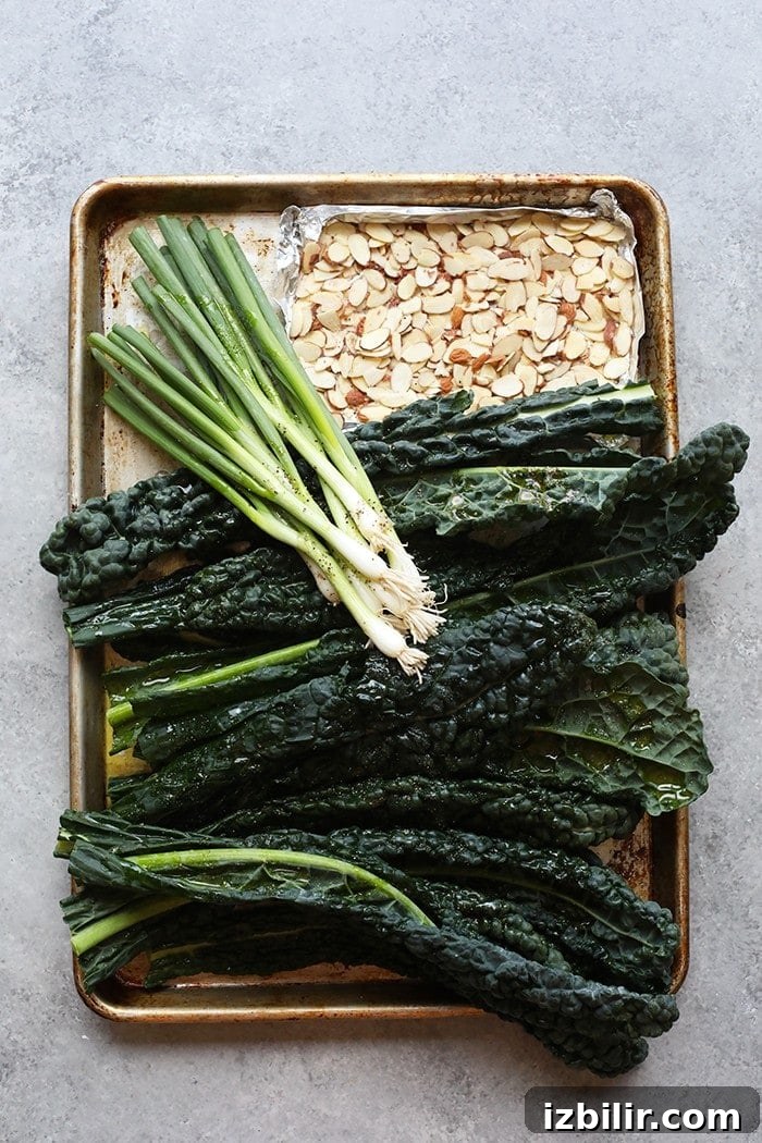Cookie sheet with kale, green onions, and almonds